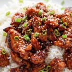 A close up phone photo of a person taking a tablespoon scoop of Copycat Panda Express Teriyaki Chicken Grilled