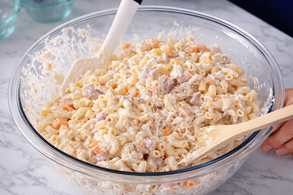 Bowl of creamy chicken macaroni salad with macaroni, shredded chicken, carrots, pineapple, and mayonnaise dressing Filipino style